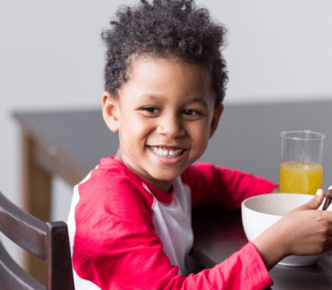 little boy eating healthy breakfast