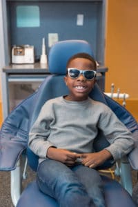 Little boy in glasses in dental chair