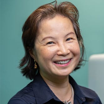 Dr. Kwong headshot on blue background