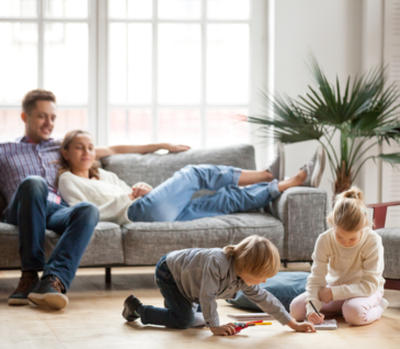 mom and dad on couch watching kids play