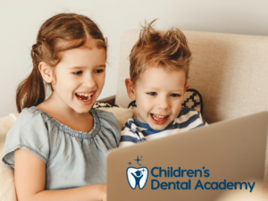 children's dental academy siblings looking at laptop