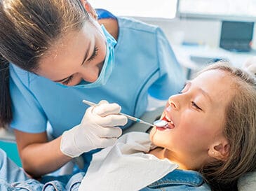 dentist looking in patients mouth